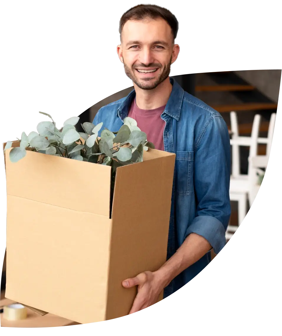 a man holding a box with greens inside it