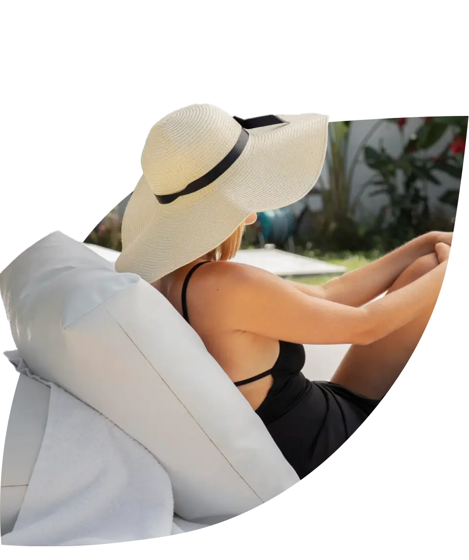 a woman with a hat driving a convertable car