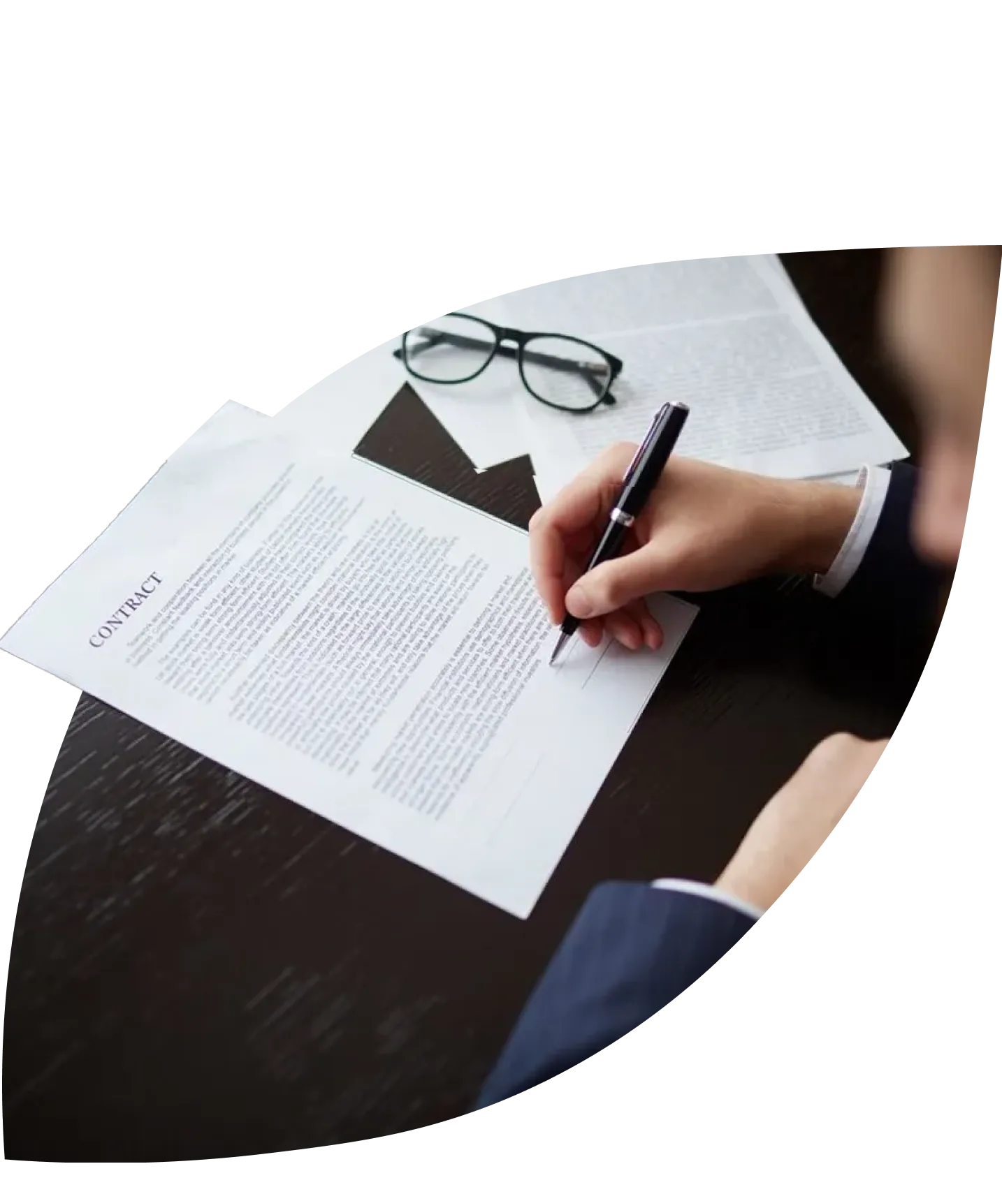 a hand signing a contract